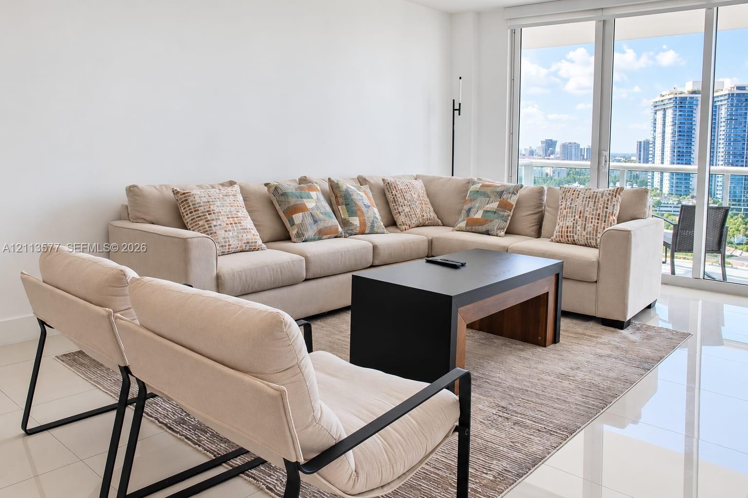 Floor-to-ceiling glass panel windows, polished tile flooring, and a glass-railed balcony Floor-to-ceiling glass panel windows, polished tile flooring, and a glass-railed balcony