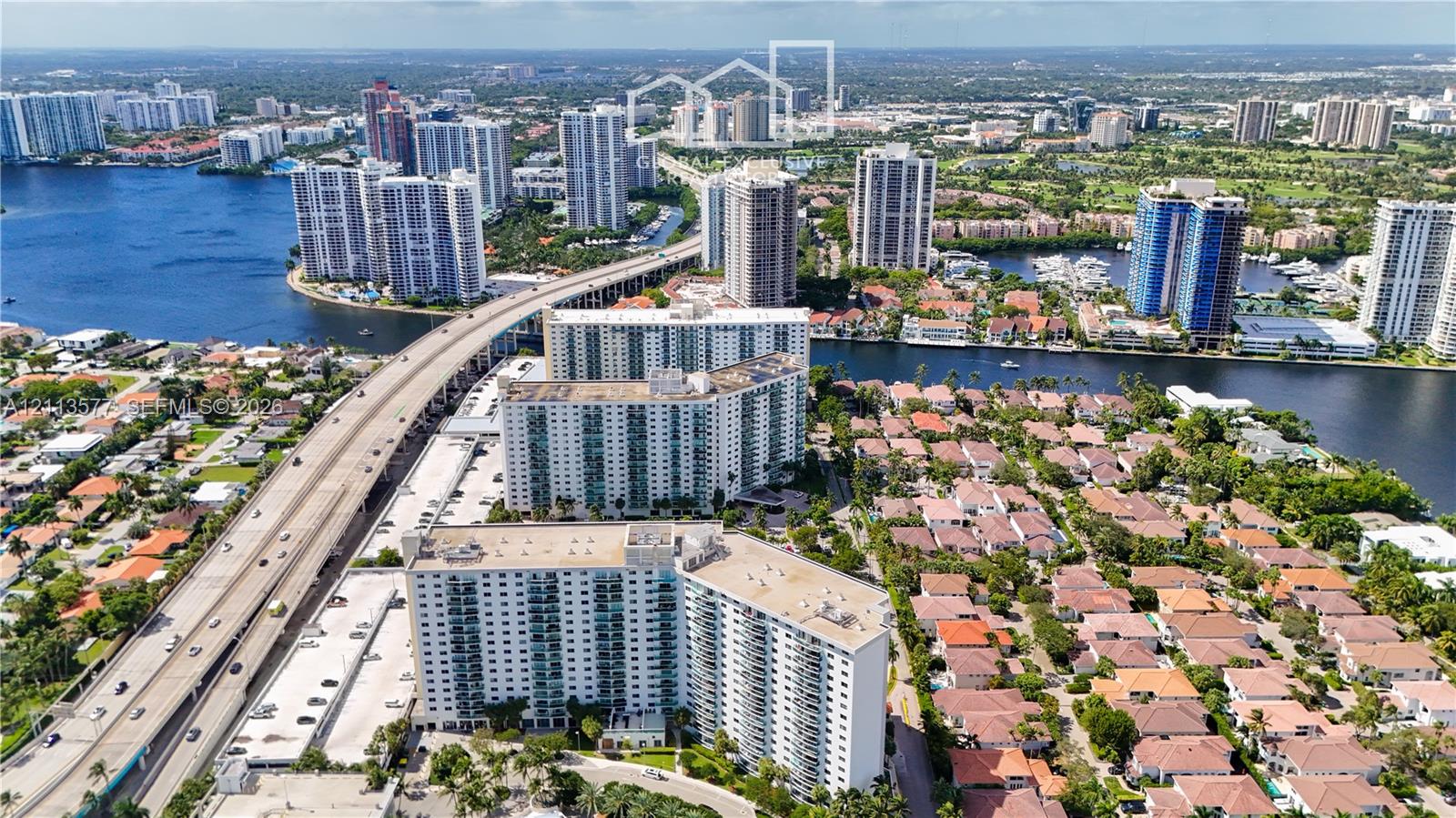 Aerial perspective featuring high-rise residential buildings situated along a waterway
