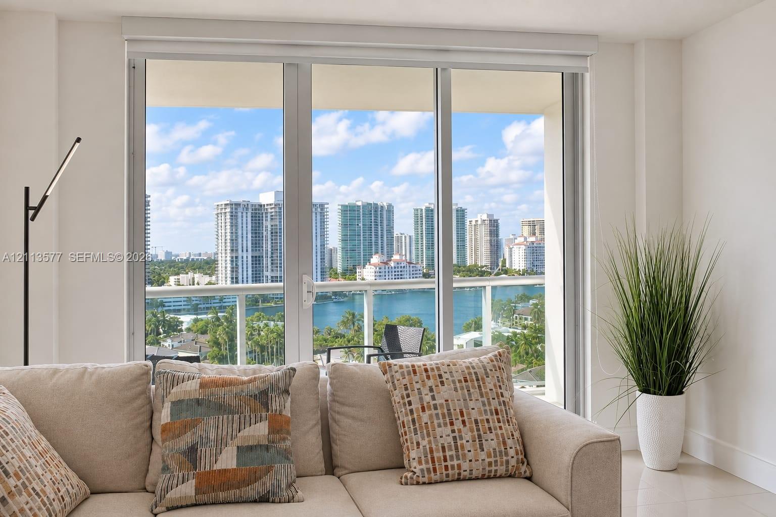 Floor-to-ceiling glass panel windows, glass-railing balcony, and expansive urban waterfront skyline scenery Floor-to-ceiling glass panel windows, glass-railing balcony, and expansive urban waterfront skyline scenery