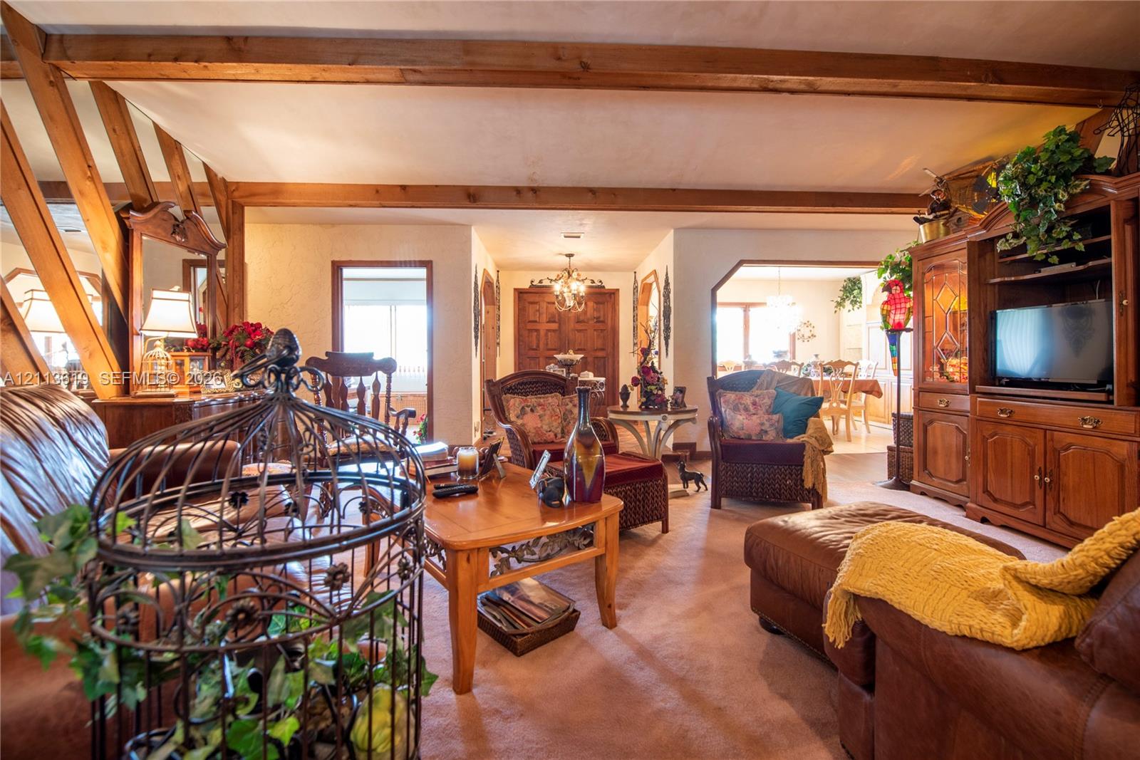 Exposed wood ceiling beams, built-in wooden cabinetry, and wooden interior door frames Exposed wood ceiling beams, built-in wooden cabinetry, and wooden interior door frames