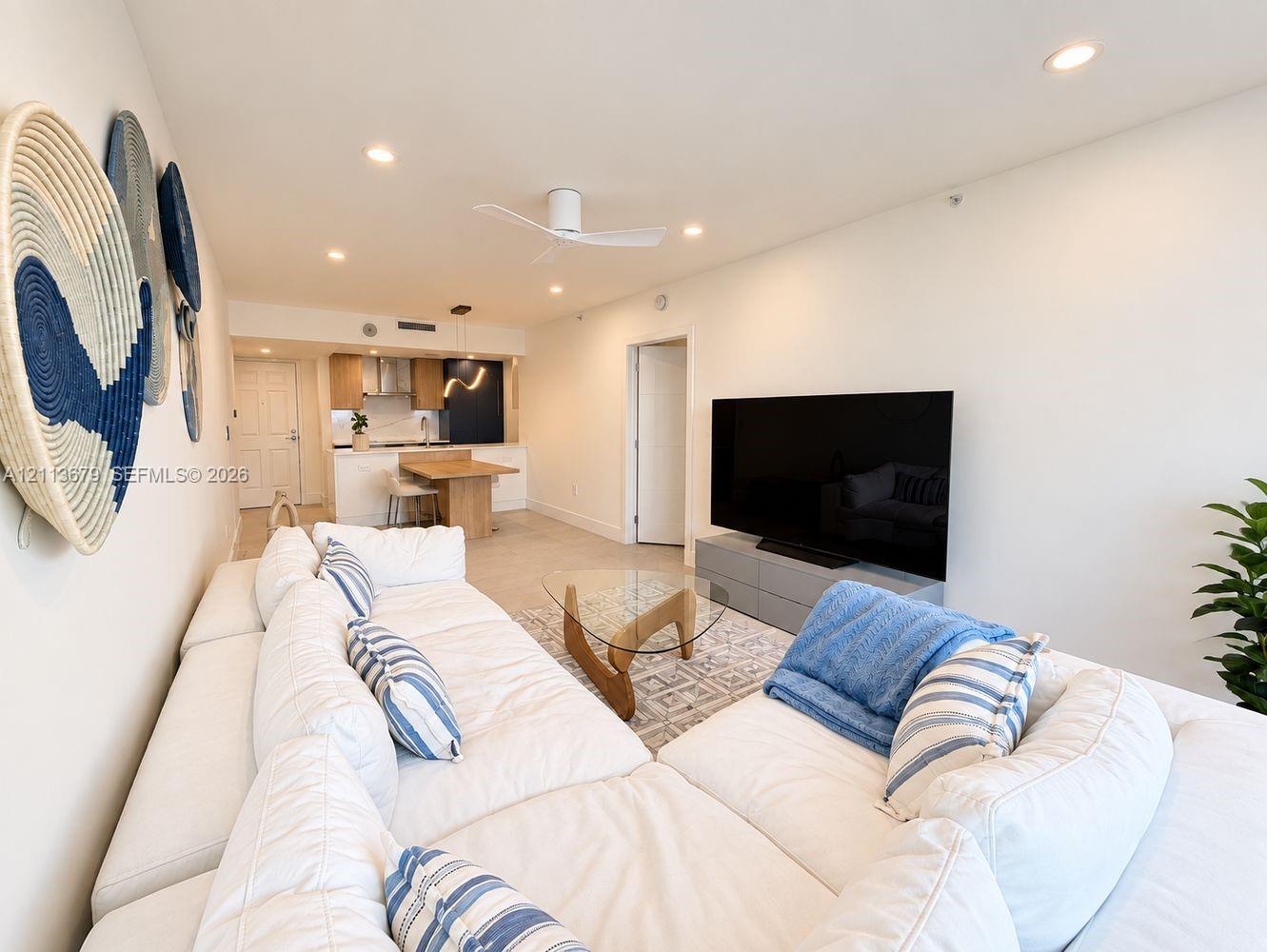 Open-concept interior featuring recessed lighting, a modern ceiling fan, tile flooring, and built in dining area