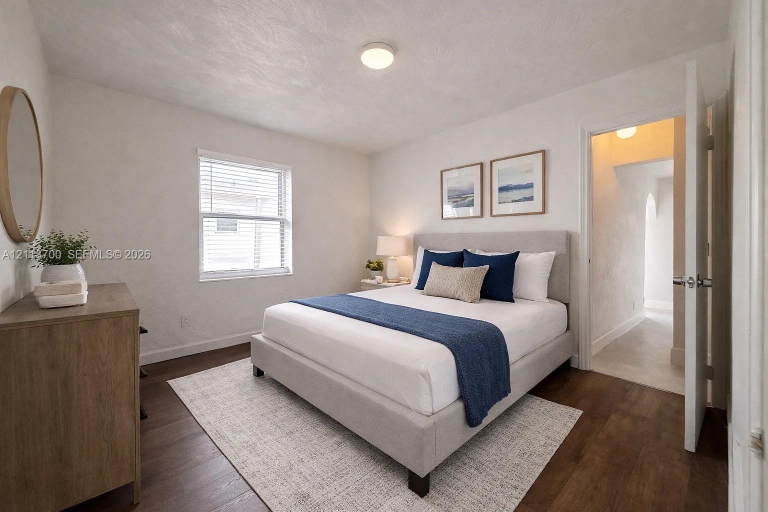 Wood-finish flooring, neutral wall tones, and single-pane window with horizontal blinds Wood-finish flooring, neutral wall tones, and single-pane window with horizontal blinds