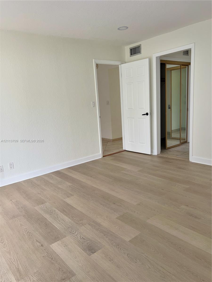 Wood-finish flooring, six-panel interior doors, and mirrored closet doors Wood-finish flooring, six-panel interior doors, and mirrored closet doors