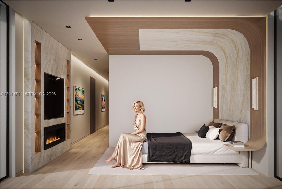 Contemporary bedroom featuring light wood-finish flooring, a wall-integrated fireplace with stone-surround shelving, recessed ceiling lighting, and a custom curved wood-veneer headboard wall panel with integrated nightstands