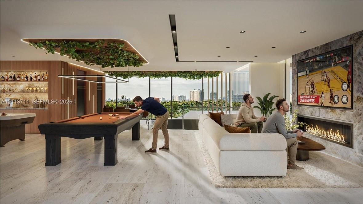 Stone flooring, linear gas fireplace with stone surround, recessed ceiling lighting, and floor-to-ceiling glass windows