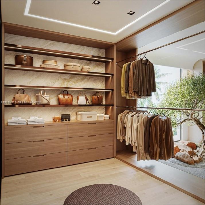 Custom built-in wood-finish cabinetry, integrated linear LED shelving, recessed ceiling lighting, and polished stone wall accents