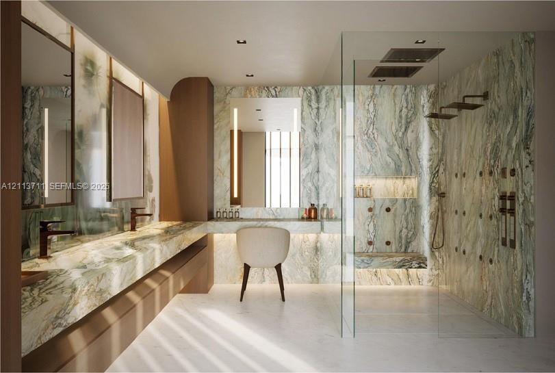 Floating vanity with stone countertop, integrated lighting, wall-mounted faucets, and walk-in glass-enclosed shower with stone surround