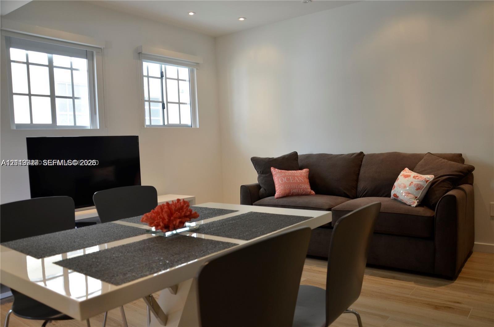 Neutral wall color, wood-finish flooring, recessed ceiling lighting, and divided-light windows Neutral wall color, wood-finish flooring, recessed ceiling lighting, and divided-light windows