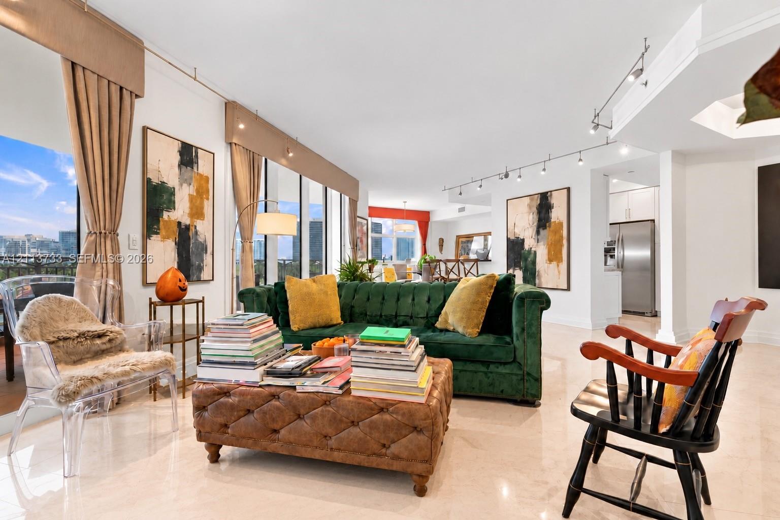 Floor-to-ceiling windows with integrated window valances, polished stone flooring, and adjustable track lighting