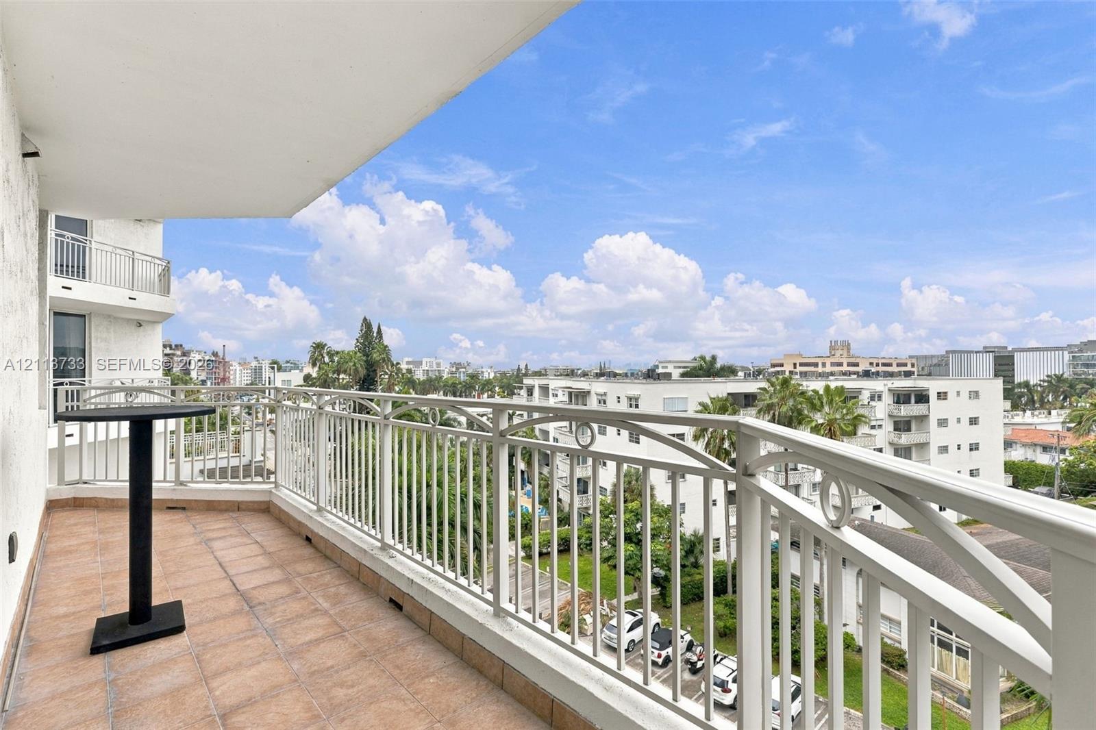 Private balcony featuring ceramic tile flooring and a decorative metal railing