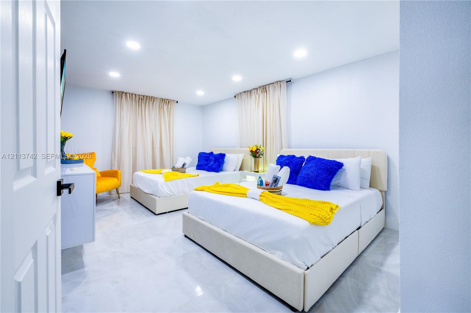 Bedroom featuring tile flooring, recessed lighting, and dual window treatments