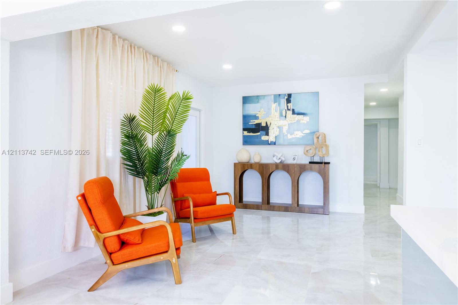 Neutral-toned stone-finish flooring and recessed ceiling lighting