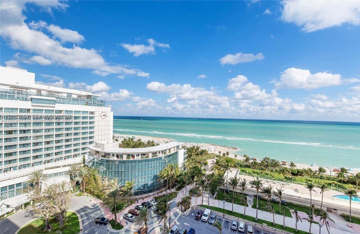 Exterior perspective of a high-rise structure featuring glass-paneled balconies, floor-to-ceiling windows, and oceanfront exposure to the Atlantic coastline