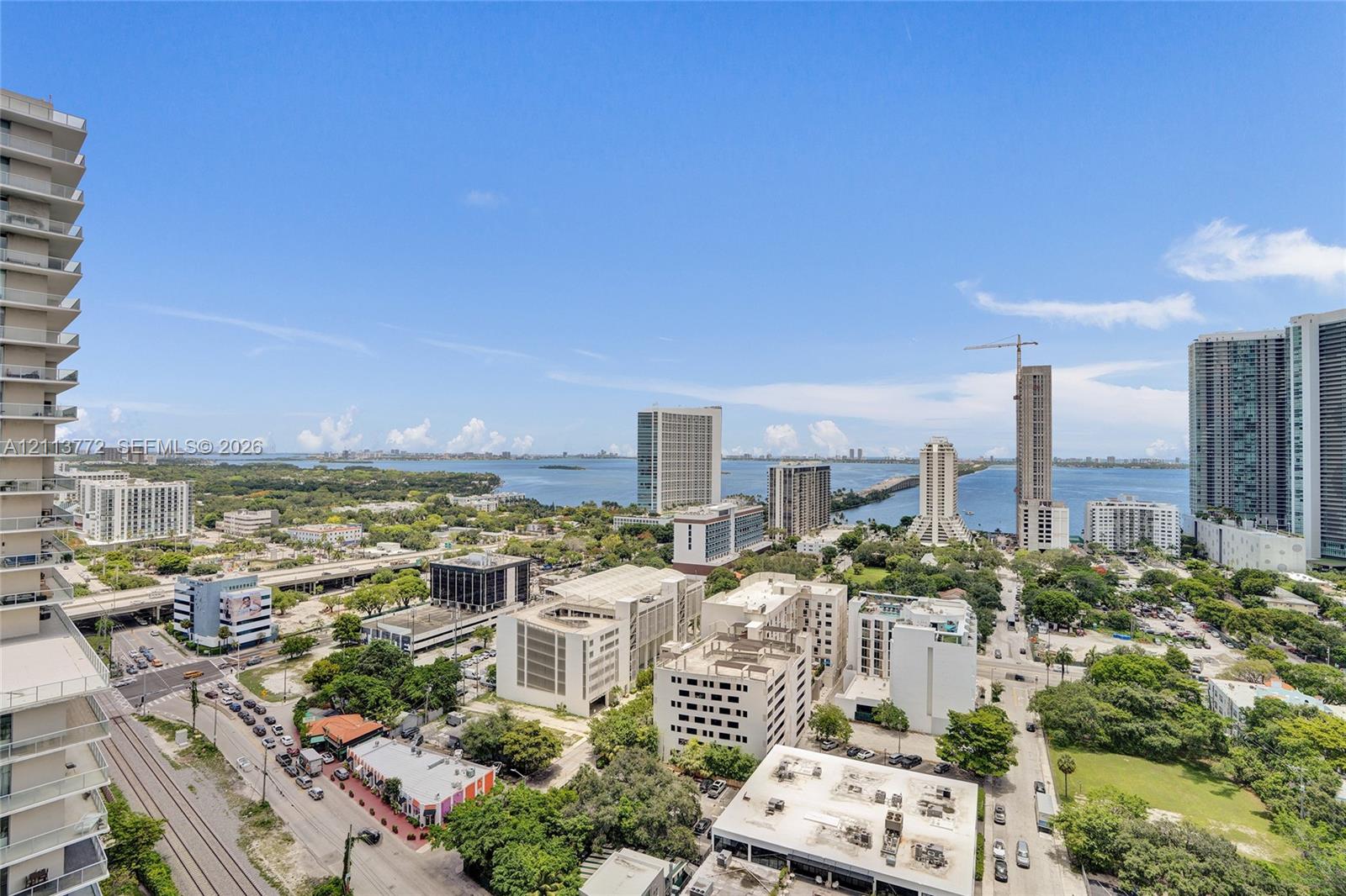 High-rise balcony featuring an elevated perspective of the surrounding cityscape and coastal waterway
