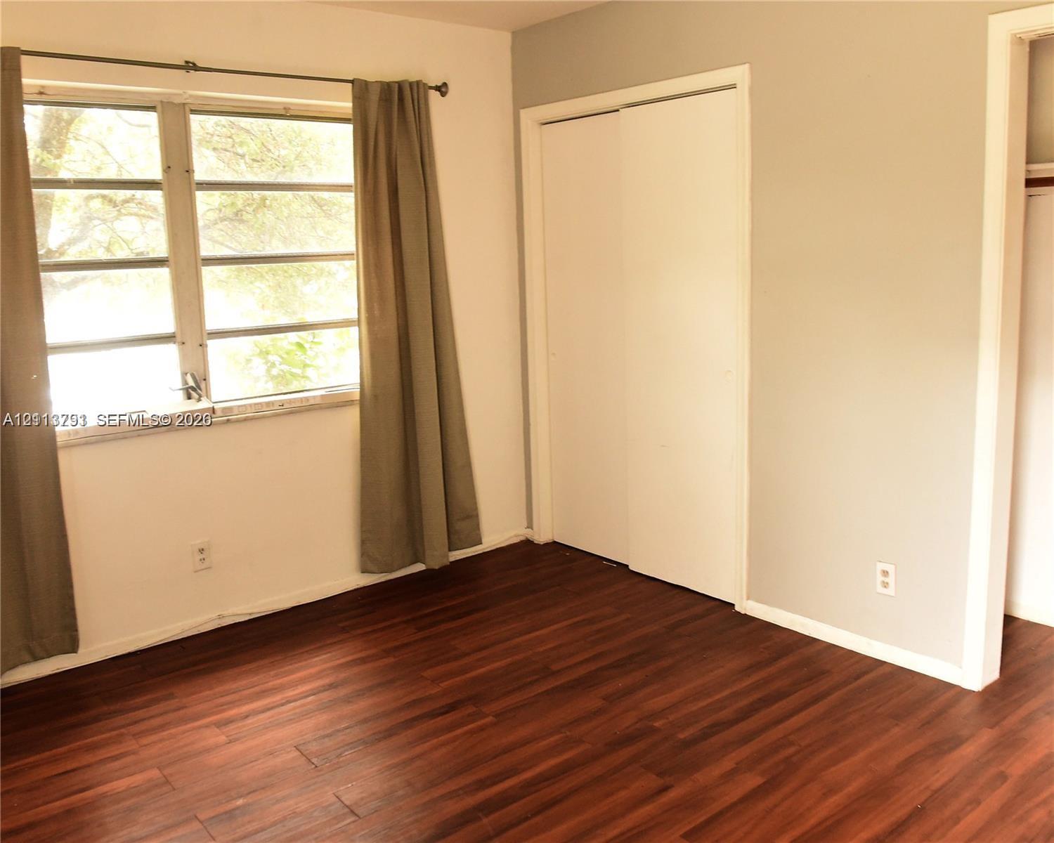 Wood-finish flooring, multi-pane windows, and a sliding closet door Wood-finish flooring, multi-pane windows, and a sliding closet door
