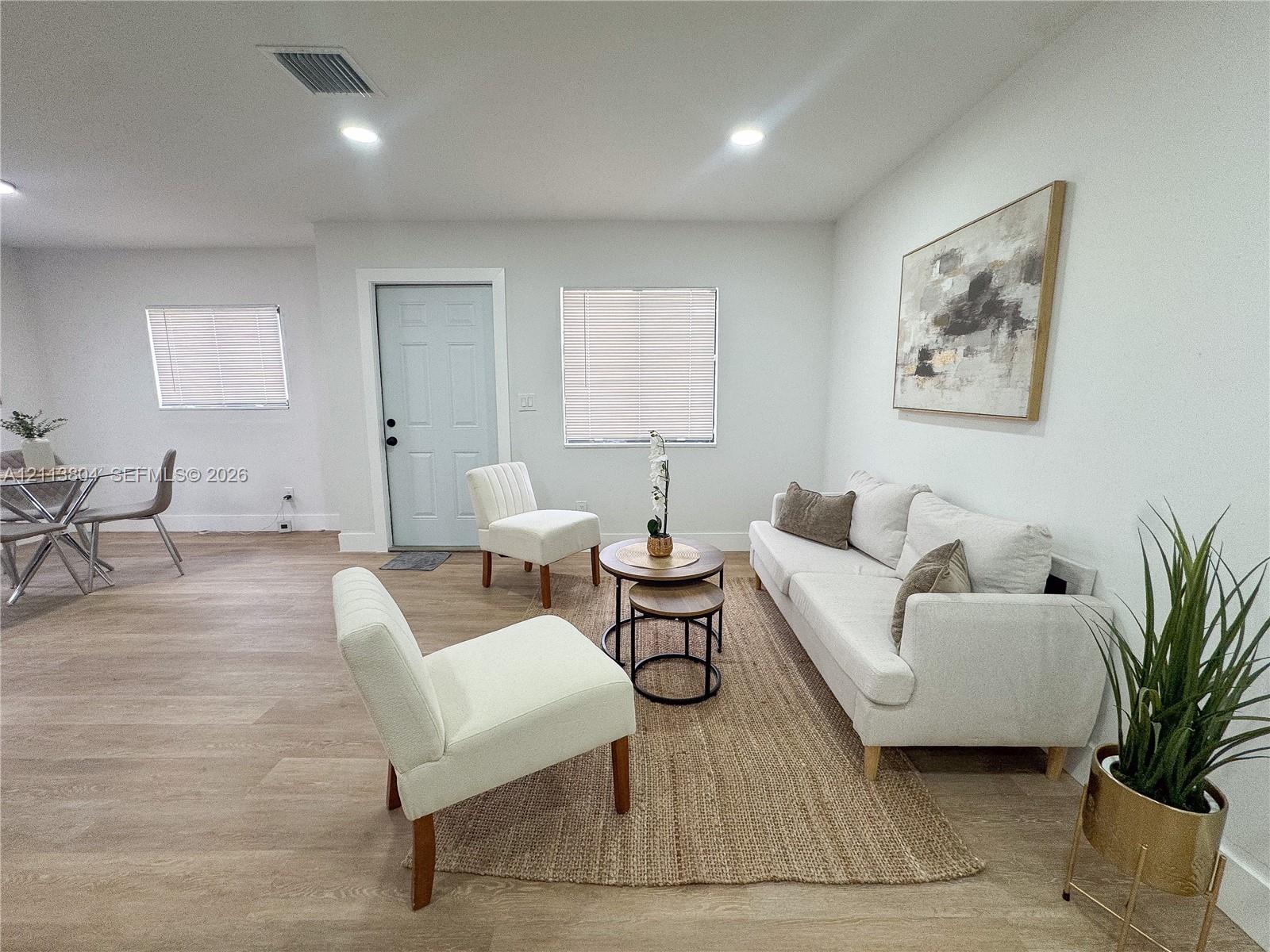 Open-concept interior featuring light-toned wood-finish flooring, recessed lighting, and crisp neutral wall color Open-concept interior featuring light-toned wood-finish flooring, recessed lighting, and crisp neutral wall color