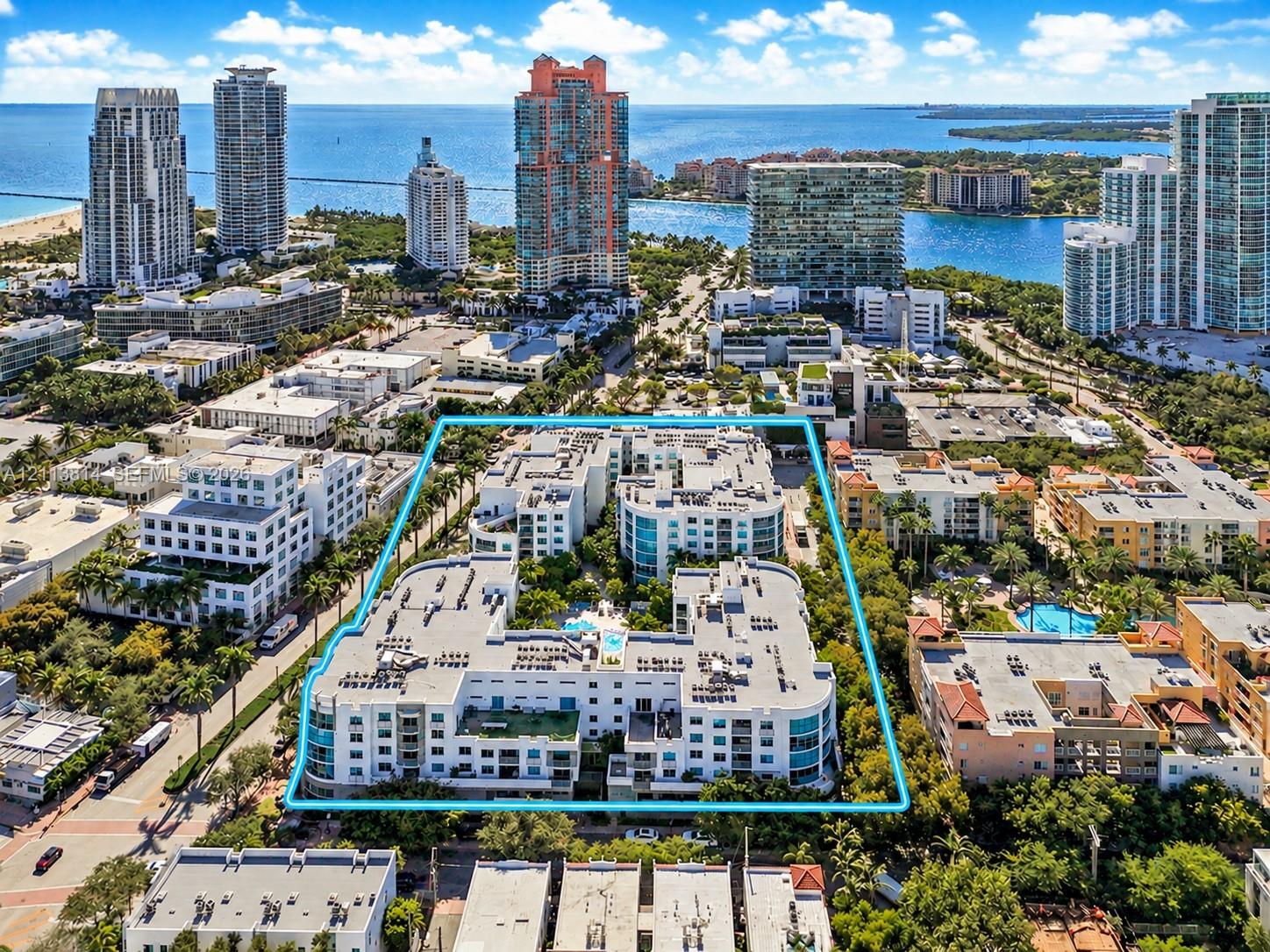 Mid-rise residential complex featuring multiple rooftop terraces, a central swimming pool, and extensive perimeter landscaping