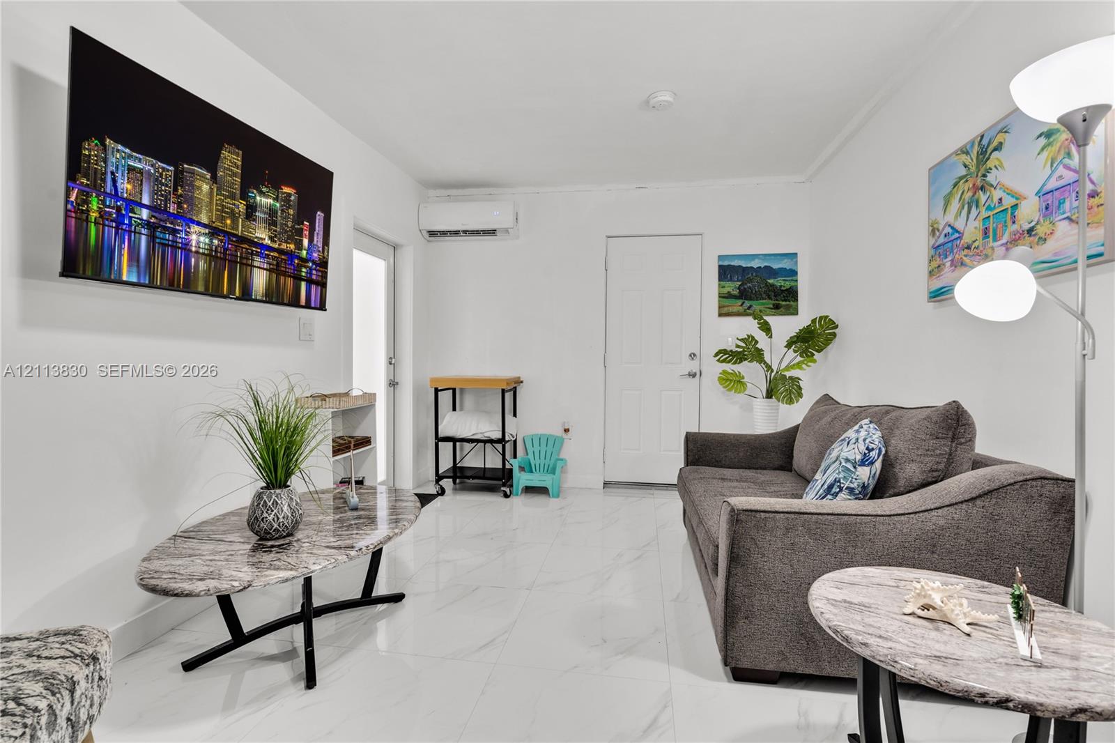 Interior space featuring white stone-finish flooring and a wall-mounted ductless mini-split HVAC unit