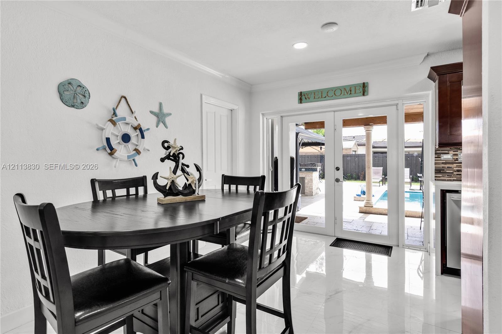 Glossy tile flooring, double glass panel doors, and recessed lighting