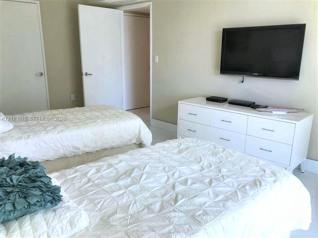 Neutral-toned wall finish featuring two interior doors and hard-surface flooring