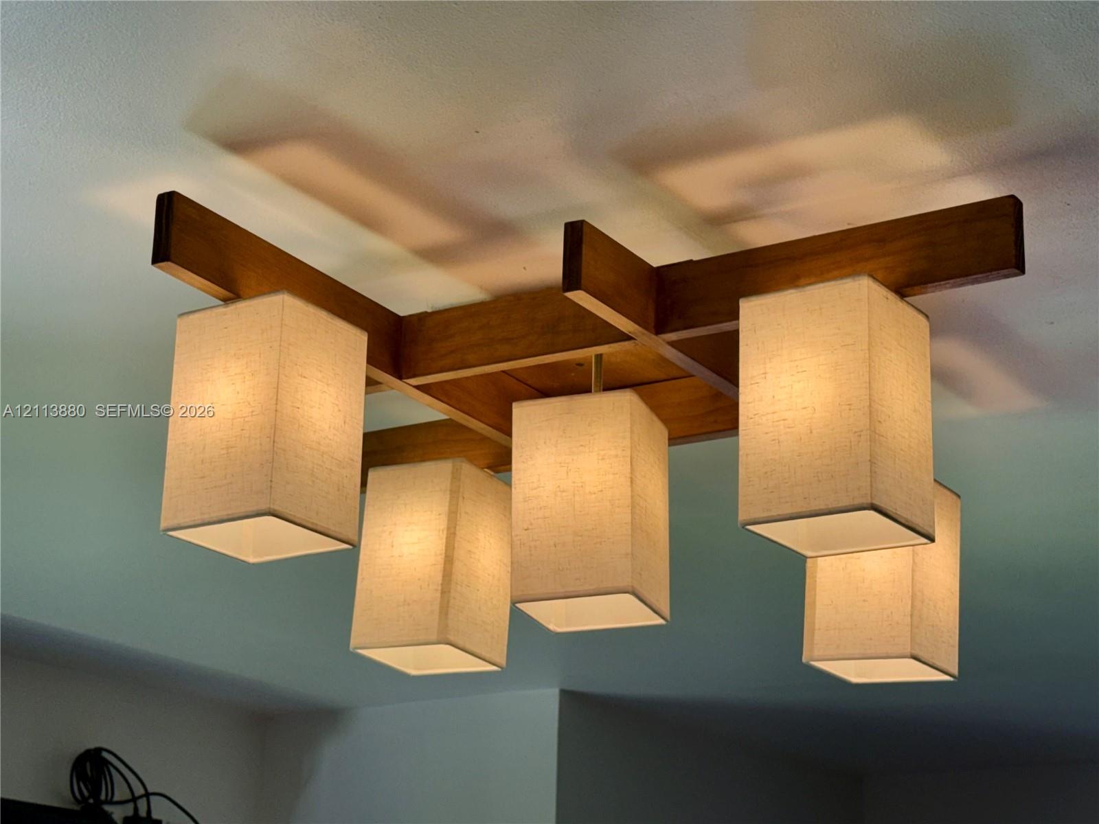 Flush-mount ceiling fixture featuring a geometric wood-finish frame and five rectangular fabric shades