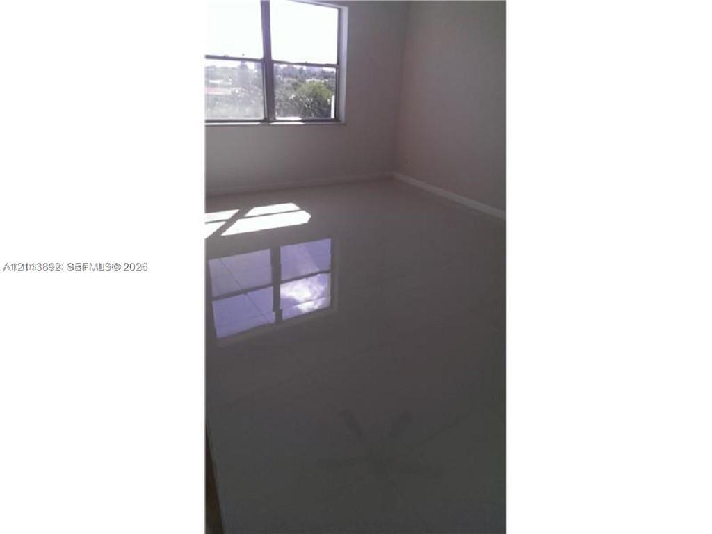 Polished tile flooring and large window providing natural light