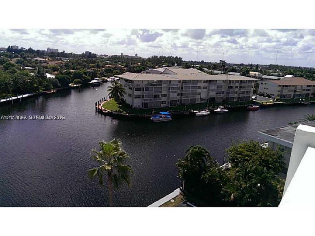 Waterfront multi-story residential building featuring balconies, canal access, and dockage Waterfront multi-story residential building featuring balconies, canal access, and dockage
