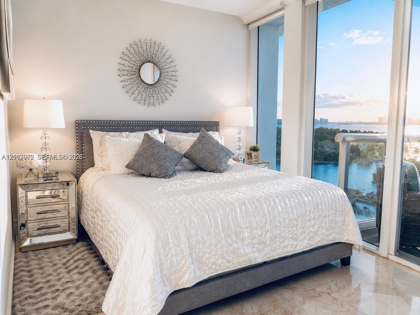 Floor-to-ceiling windows featuring expansive water scenery, neutral wall finishes, and polished tile flooring