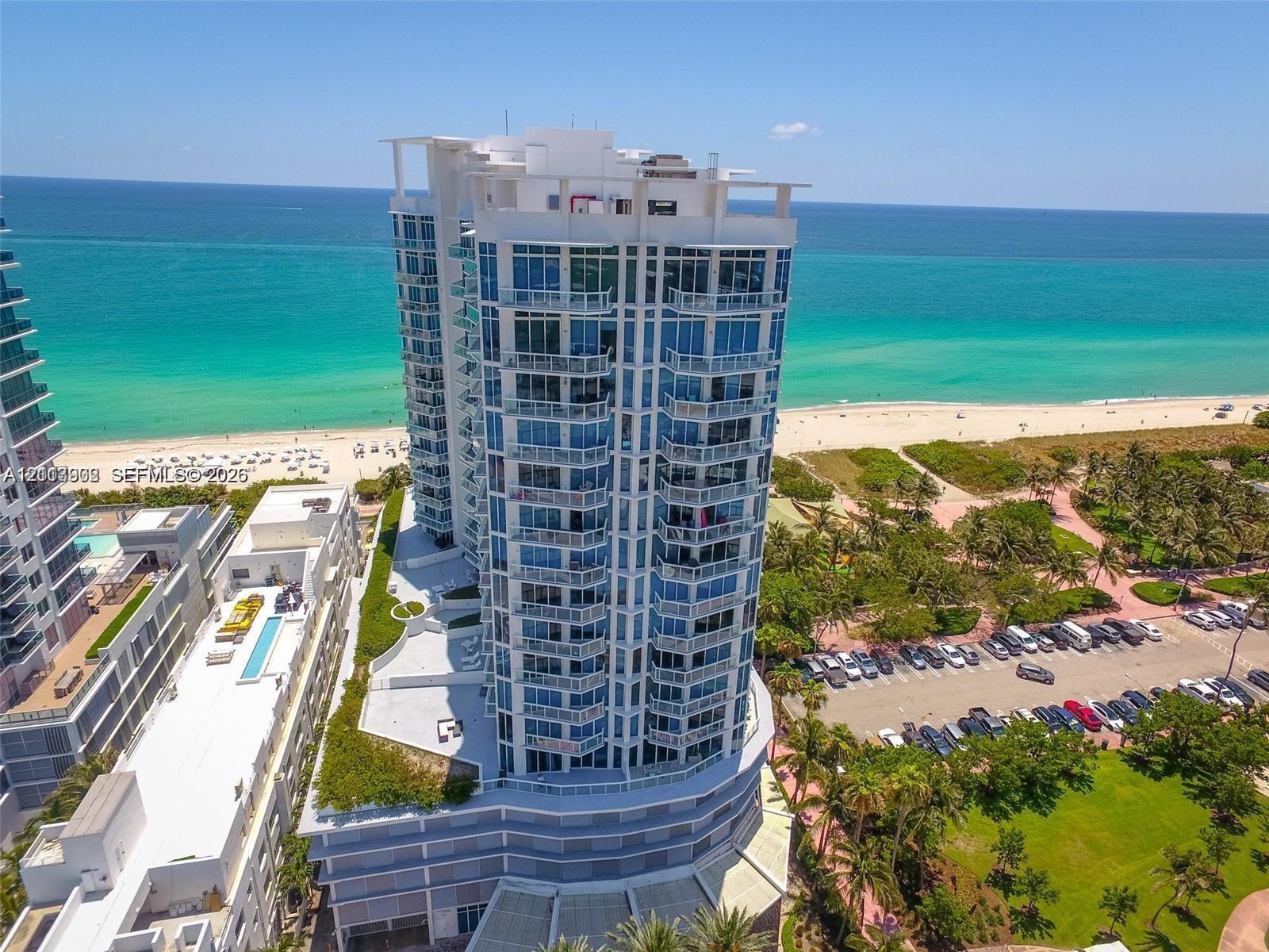 High-rise residential tower featuring floor-to-ceiling glass windows, wraparound balconies, and direct oceanfront positioning High-rise residential tower featuring floor-to-ceiling glass windows, wraparound balconies, and direct oceanfront positioning