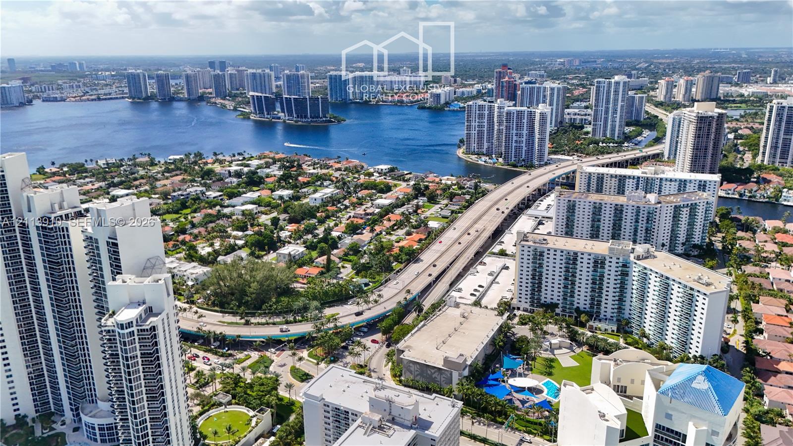 Aerial perspective showcasing waterfront proximity, coastal high-rise architecture, and expansive urban density Aerial perspective showcasing waterfront proximity, coastal high-rise architecture, and expansive urban density