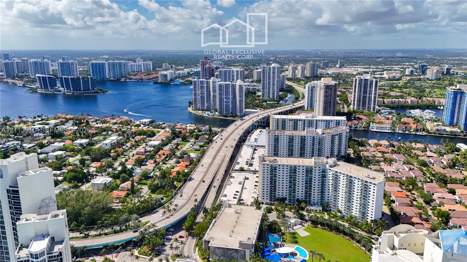 Aerial perspective showcasing waterfront access, proximity to major thoroughfares, and surrounding high-rise infrastructure Aerial perspective showcasing waterfront access, proximity to major thoroughfares, and surrounding high-rise infrastructure