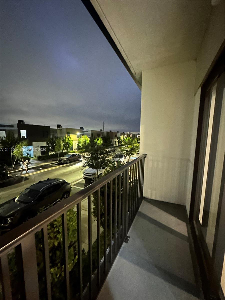 Private balcony with metal railings and concrete flooring