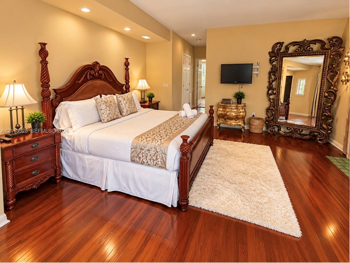 Wood-finish flooring, recessed ceiling lighting, and a neutral wall palette