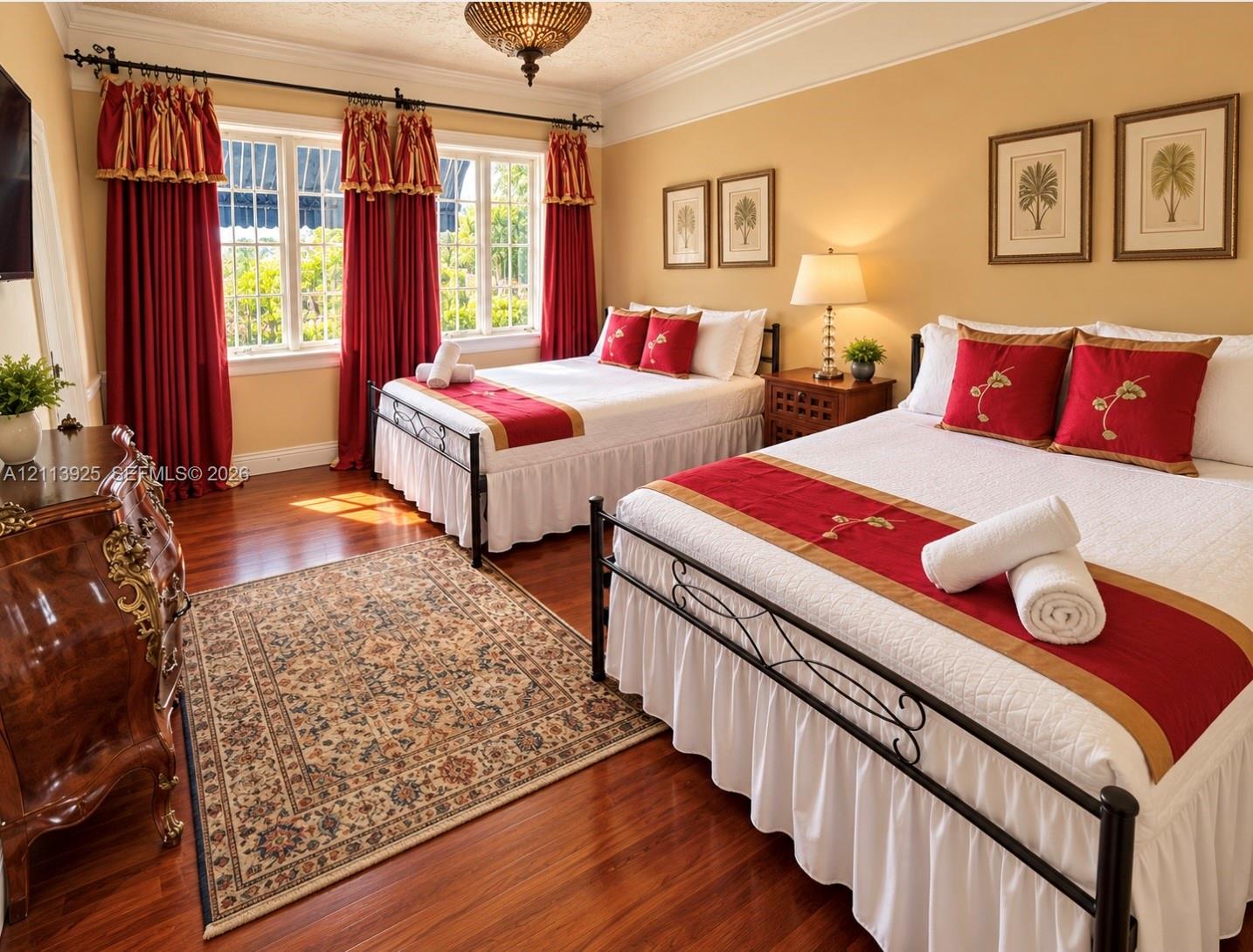 Room featuring wood-finish flooring, crown molding, multi-pane windows, and a decorative ceiling-mounted light fixture