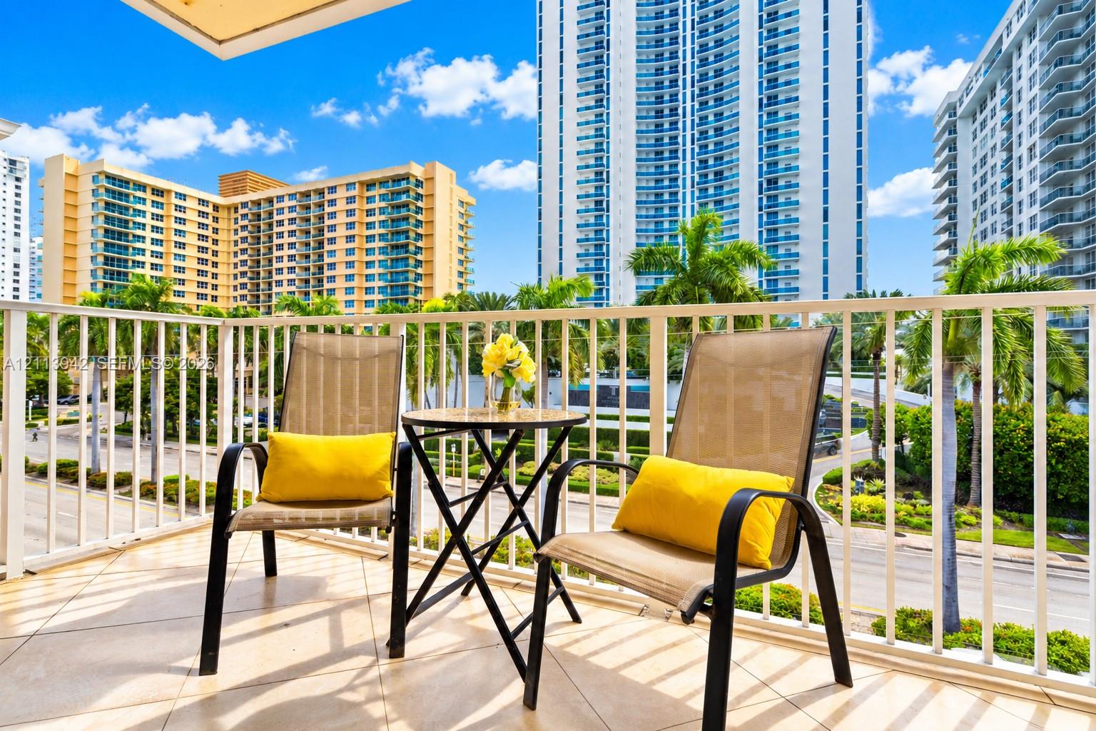 Private balcony featuring neutral ceramic tile flooring and a white metal safety railing