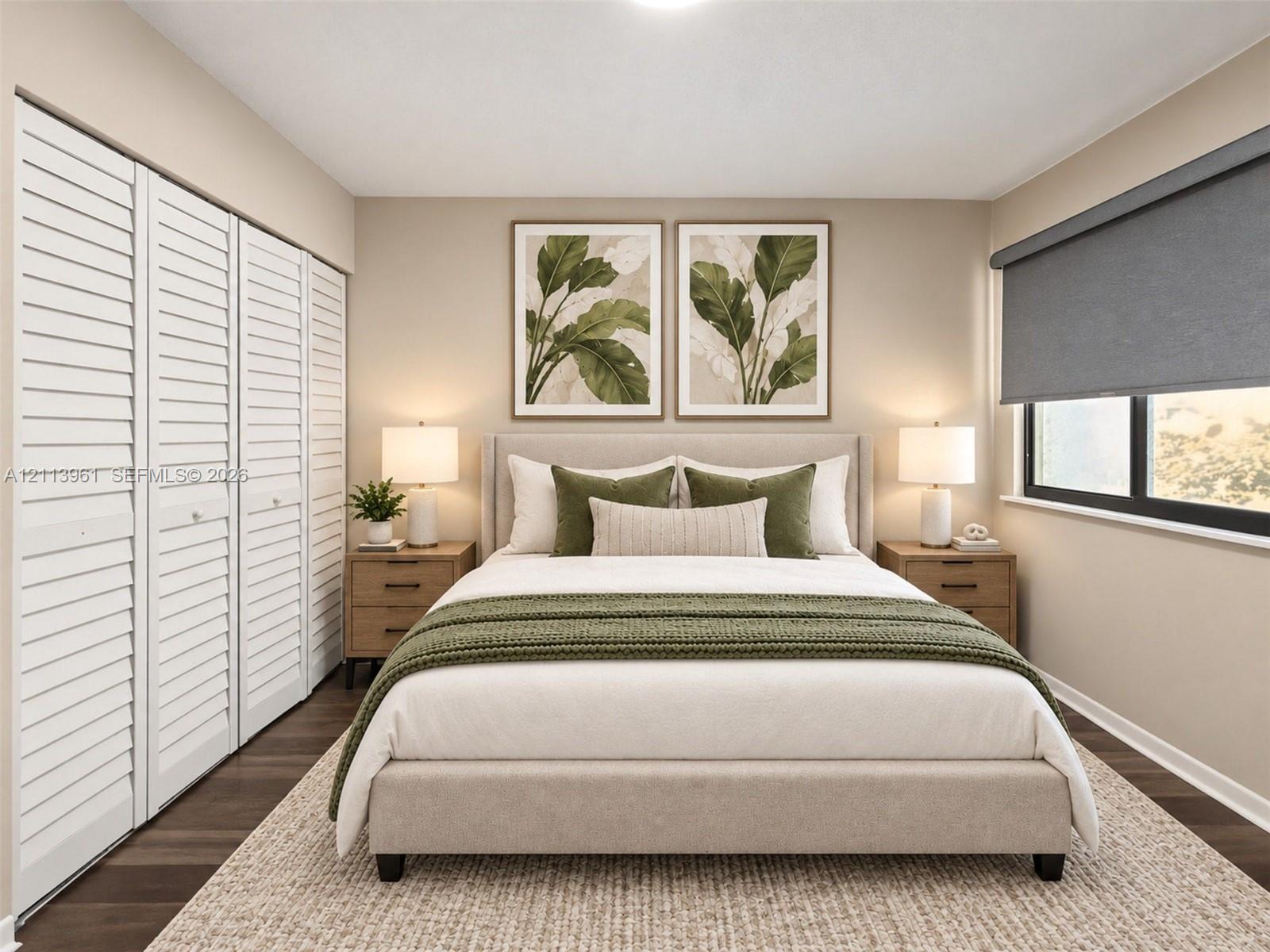 Room featuring white louvered closet doors, dark wood-finish flooring, and a window equipped with a retractable roller shade