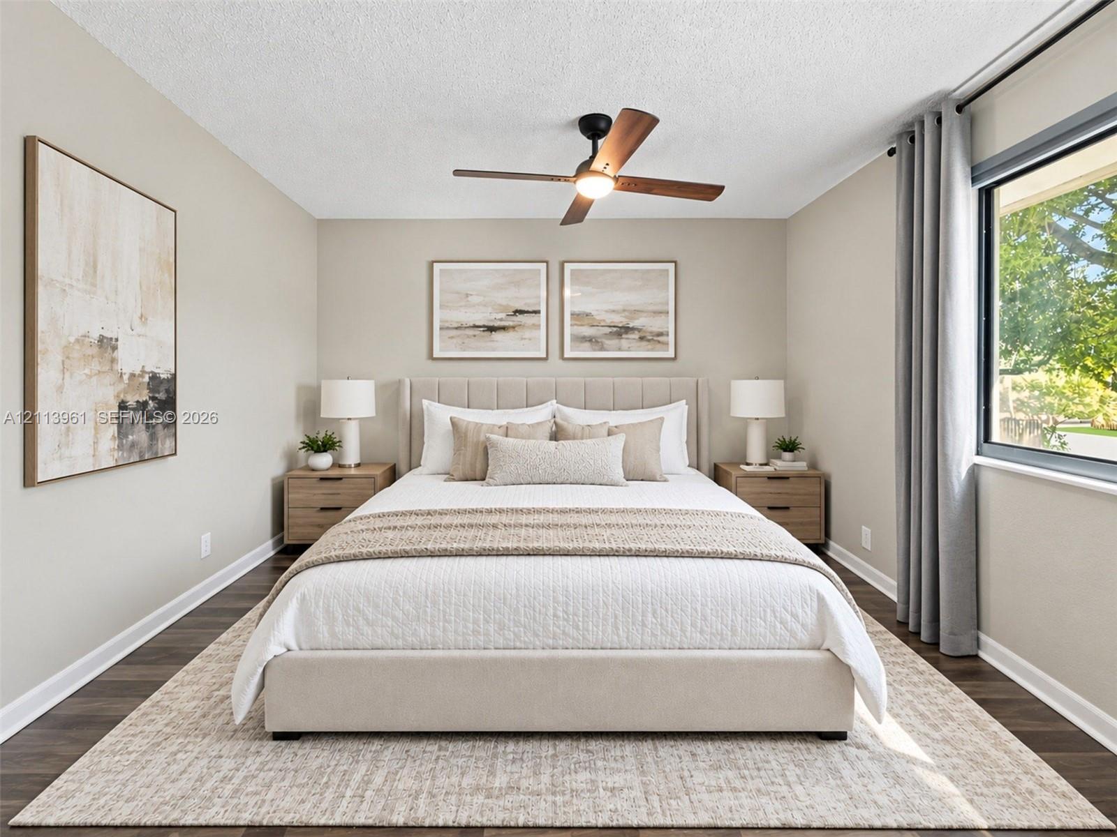 Room featuring wood-finish flooring, a matte black ceiling fan with an integrated light fixture, and a large window