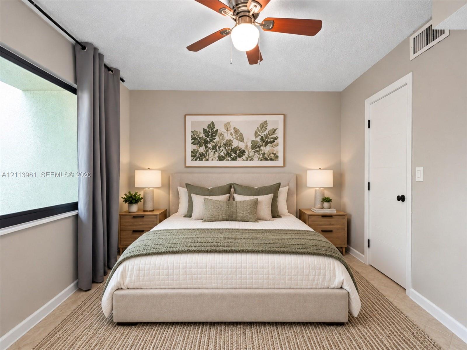 Neutral-toned room featuring a central ceiling fan with an integrated light fixture, horizontal paneled door with matte black hardware, and large-format window Neutral-toned room featuring a central ceiling fan with an integrated light fixture, horizontal paneled door with matte black hardware, and large-format window