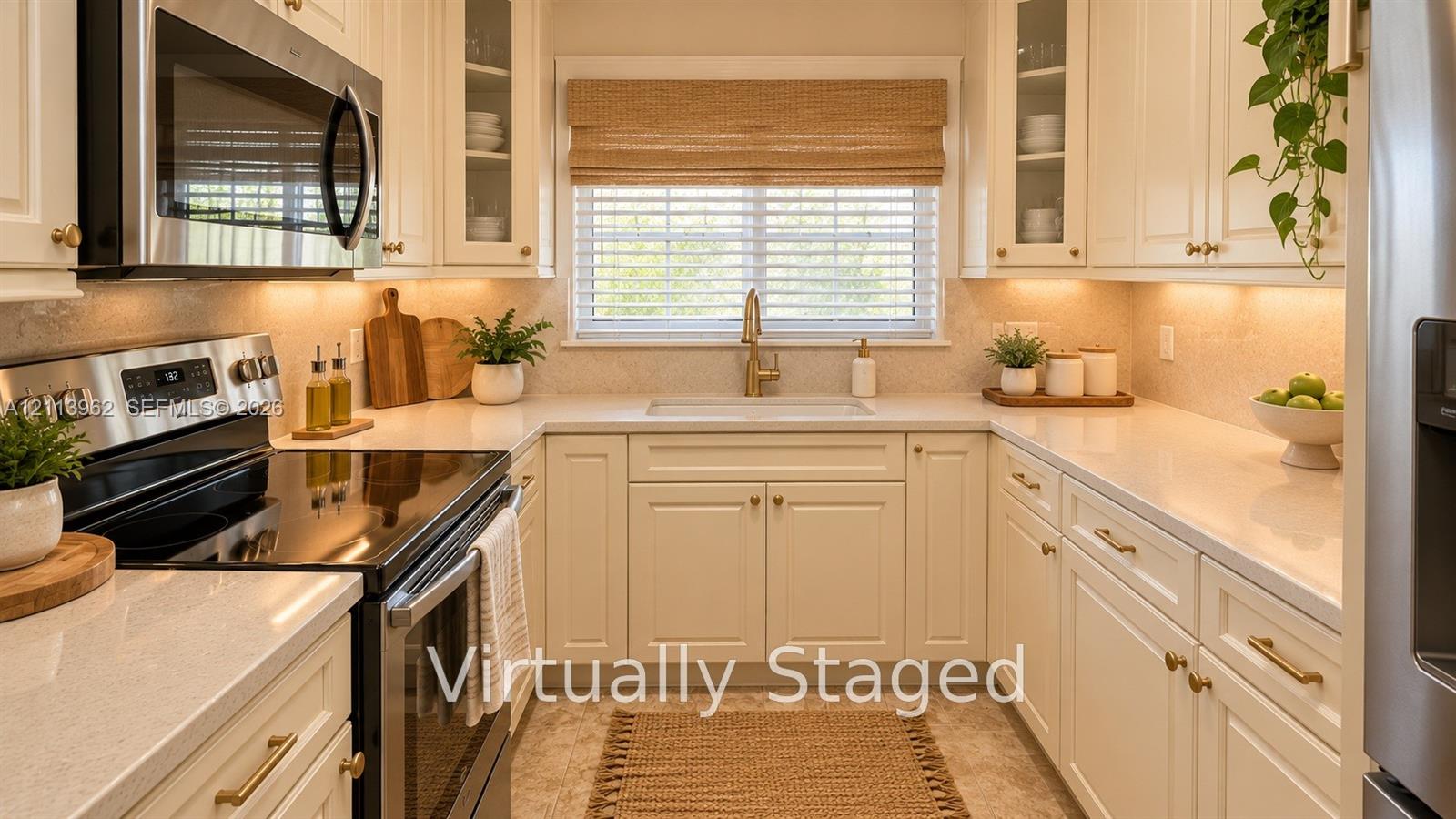 Kitchen featuring white shaker-style cabinetry with glass-front uppers, solid surface countertops, stainless steel appliances, and under-cabinet lighting Kitchen featuring white shaker-style cabinetry with glass-front uppers, solid surface countertops, stainless steel appliances, and under-cabinet lighting