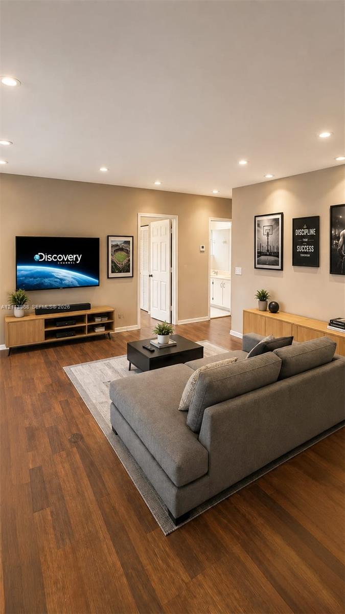 Living area featuring wood-finish flooring, recessed lighting, and neutral wall tones