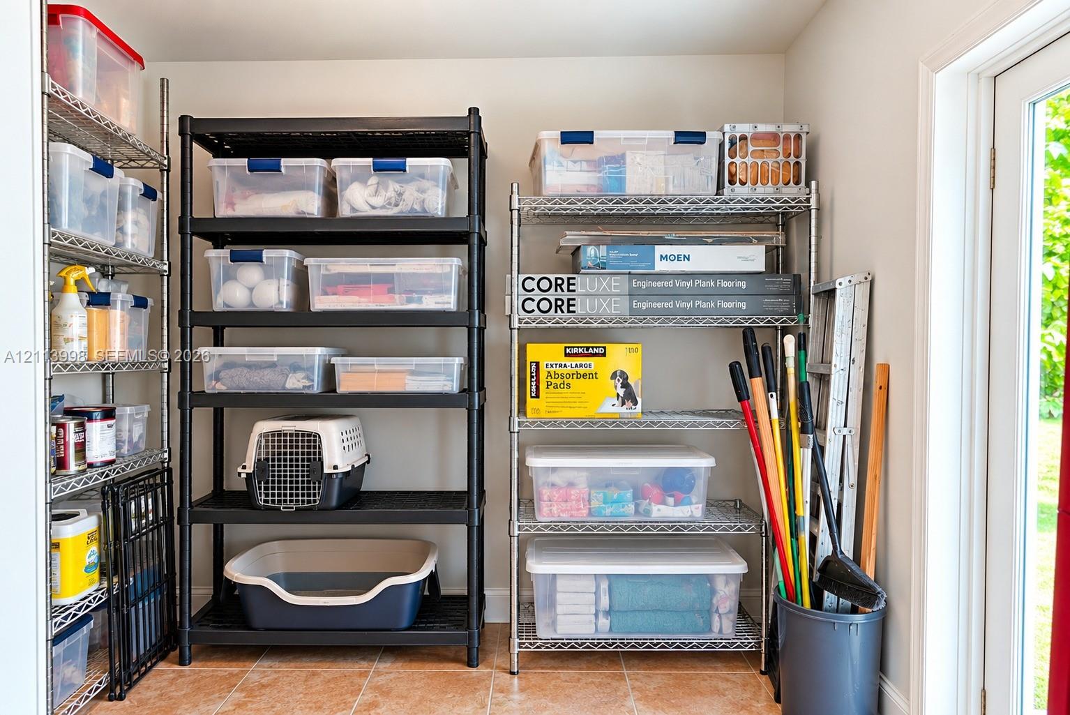 Storage area featuring tile flooring and a glass-paneled door