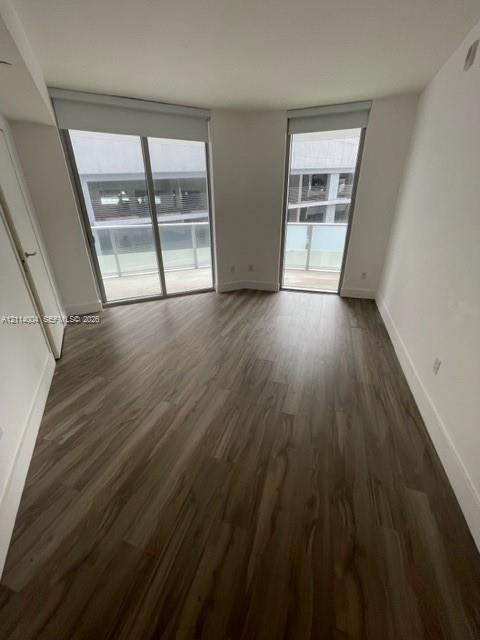 Wood-finish flooring, dual floor-to-ceiling glass sliding doors, and private balcony access Wood-finish flooring, dual floor-to-ceiling glass sliding doors, and private balcony access
