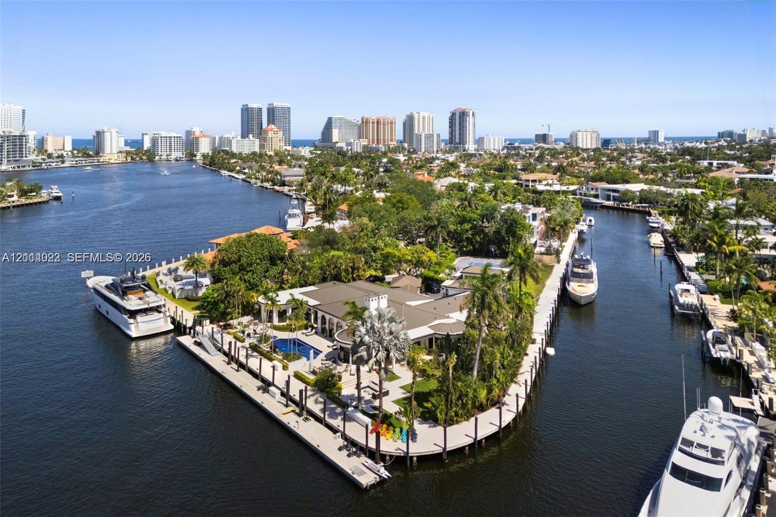 Waterfront estate on a point lot featuring dual-sided deep-water dockage, a tiled swimming pool, and extensive concrete perimeter decking Waterfront estate on a point lot featuring dual-sided deep-water dockage, a tiled swimming pool, and extensive concrete perimeter decking