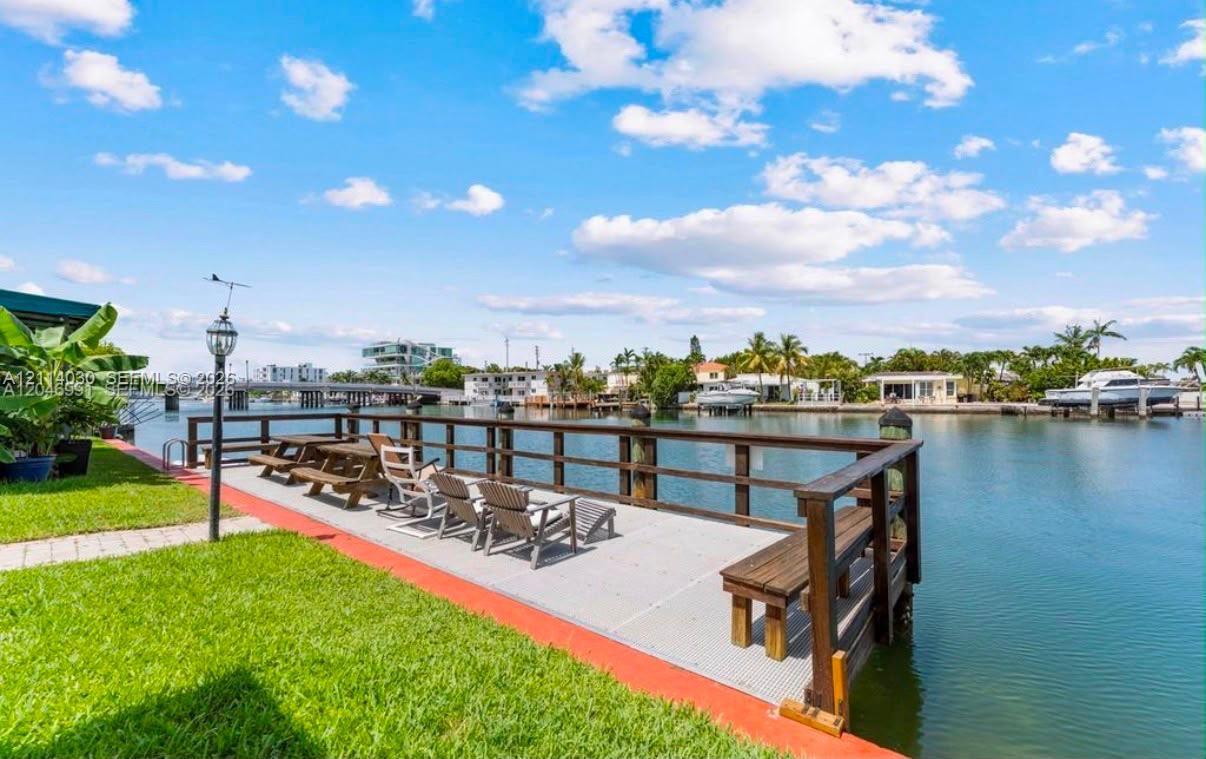 Waterfront dock featuring durable composite decking, timber railings, built-in benches, and direct canal access