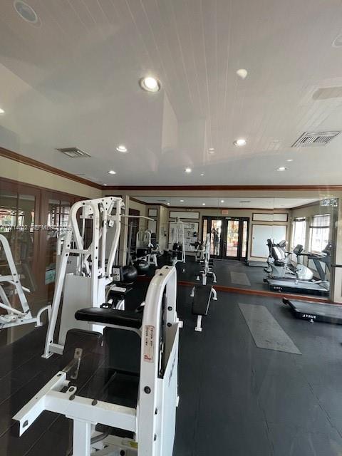 Fitness space featuring tongue-and-groove paneled ceiling, recessed lighting, full-length wall mirrors, and crown molding
