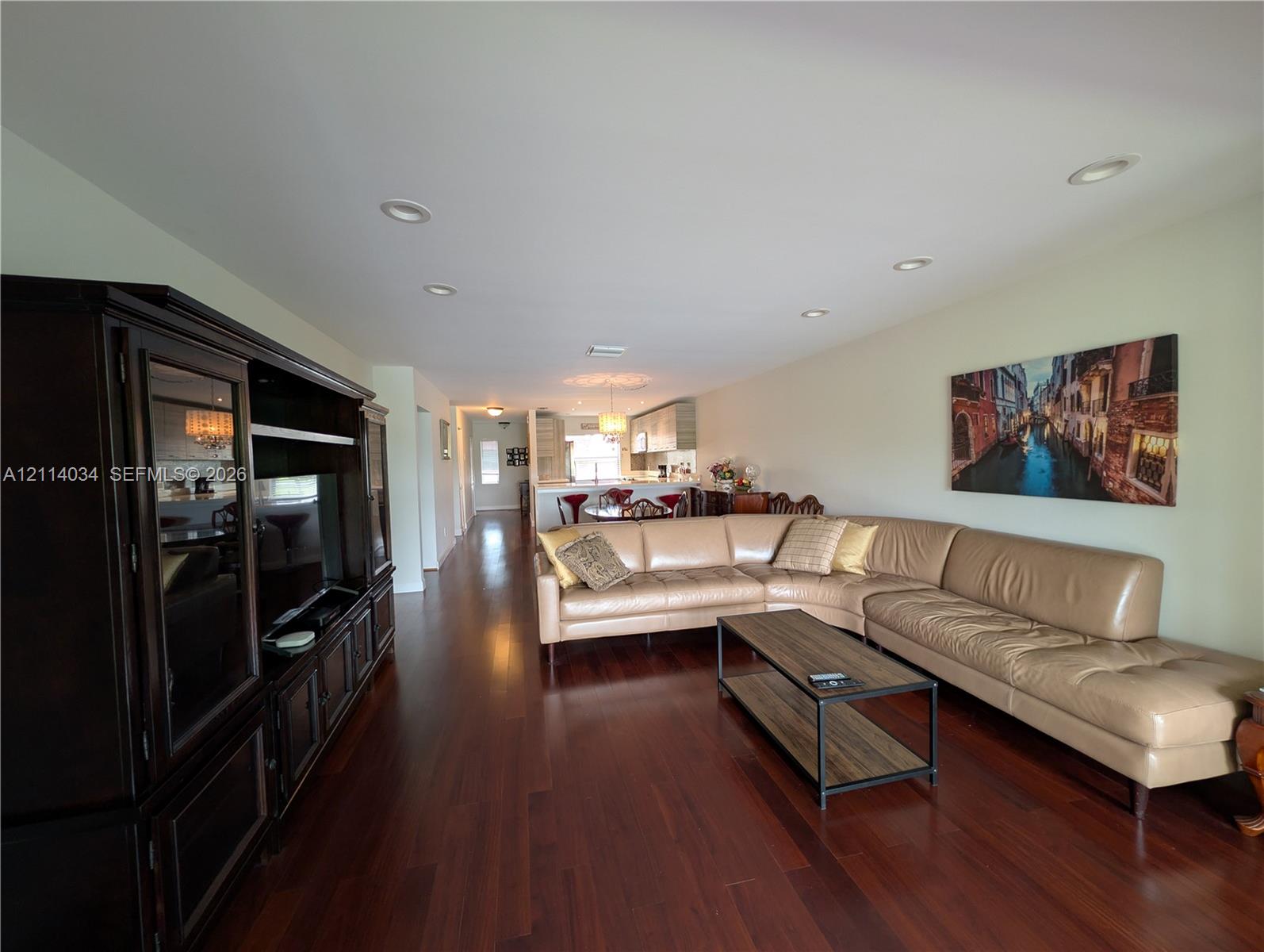 Open interior featuring wood-finish flooring, recessed lighting, and a built-in cabinetry unit