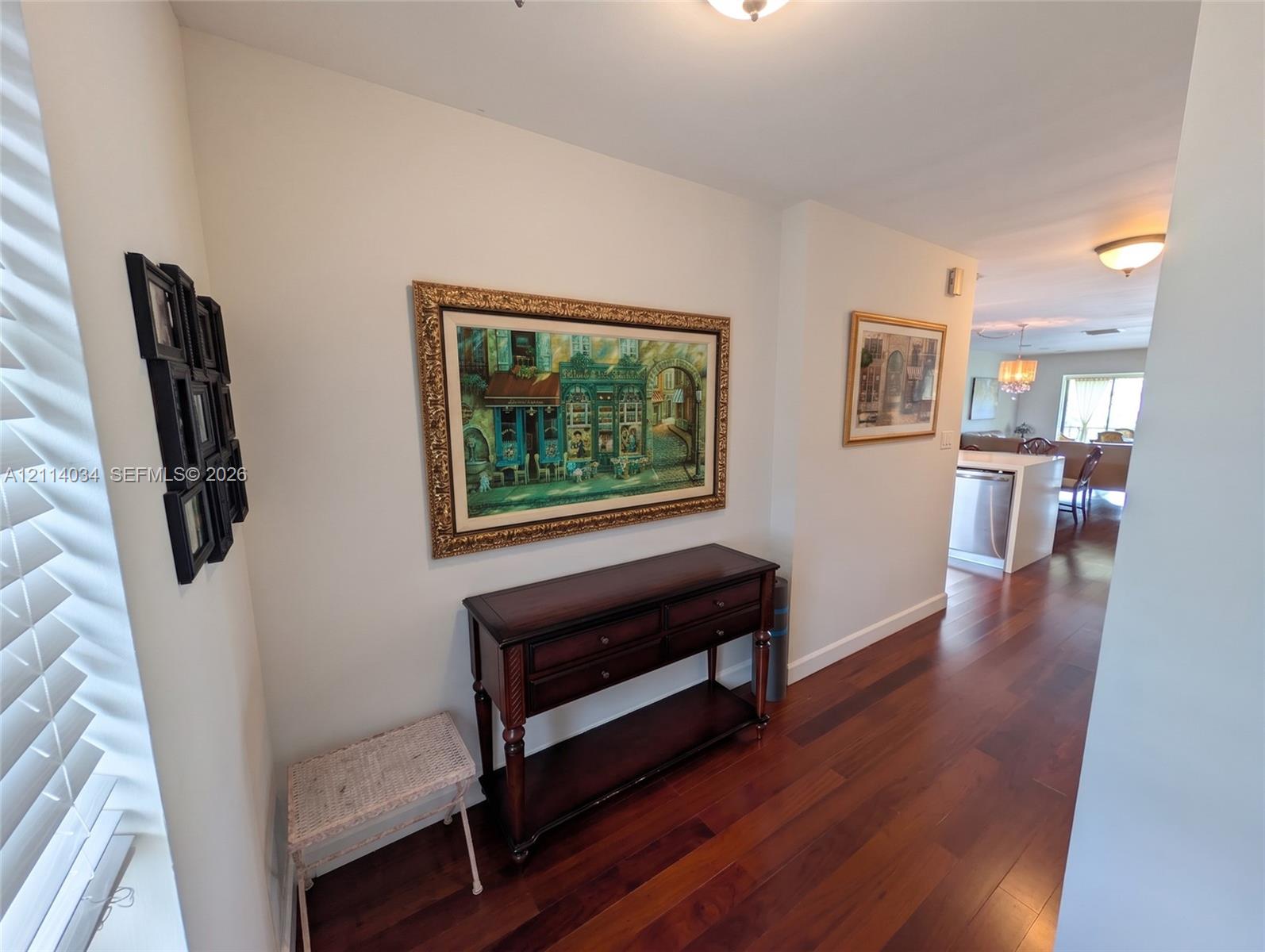 Entry area featuring wood-finish flooring, white walls, and flush-mount ceiling lighting