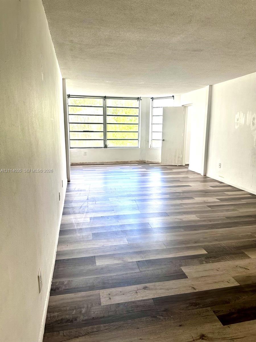 Interior space featuring wood-finish flooring and large multi-pane windows