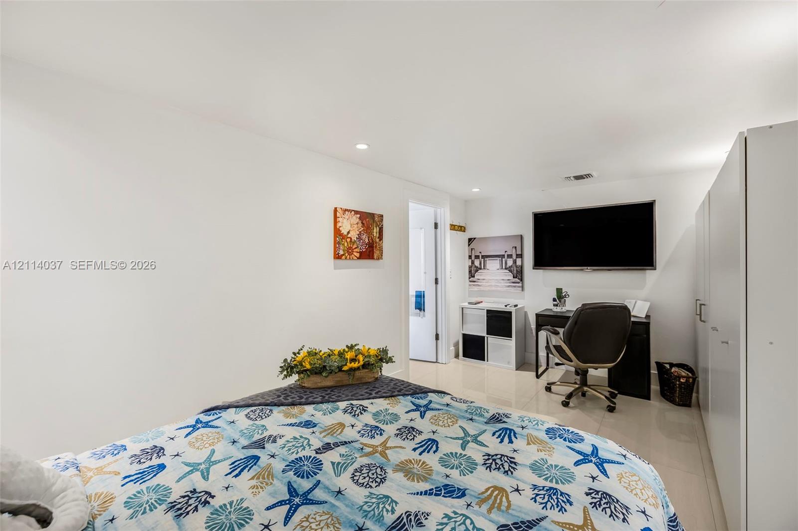 Bright room featuring recessed lighting, polished tile flooring, and integrated white cabinetry
