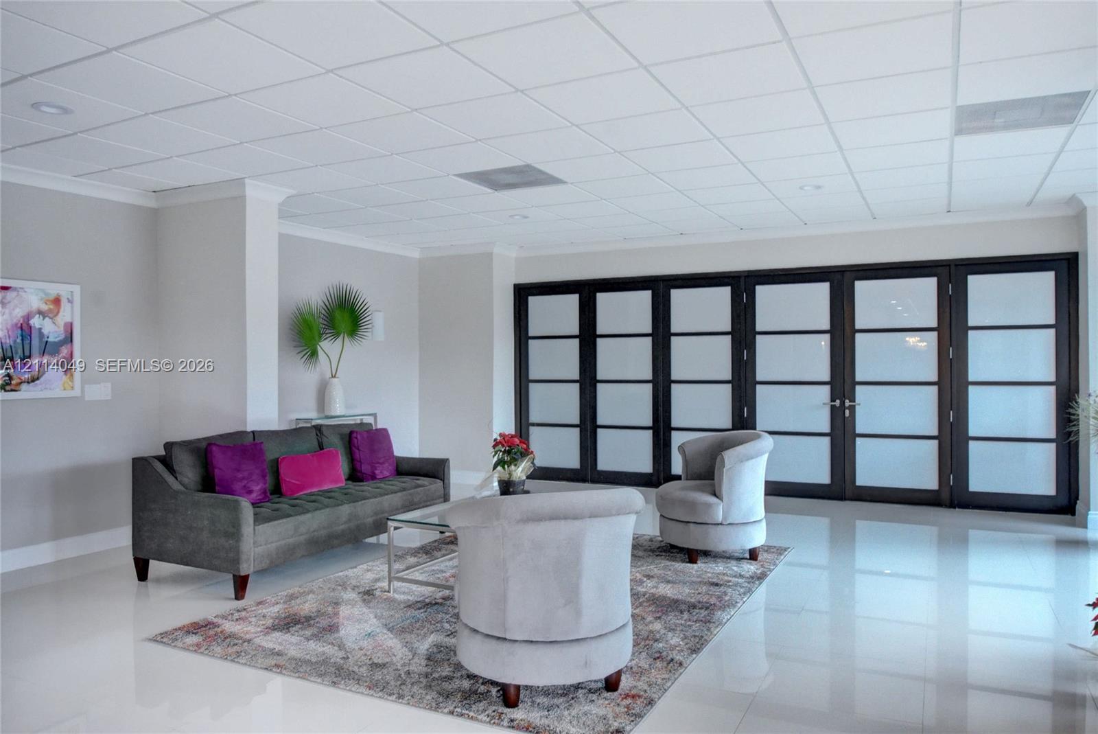 Interior space featuring polished tile flooring, recessed lighting, and a drop ceiling Interior space featuring polished tile flooring, recessed lighting, and a drop ceiling